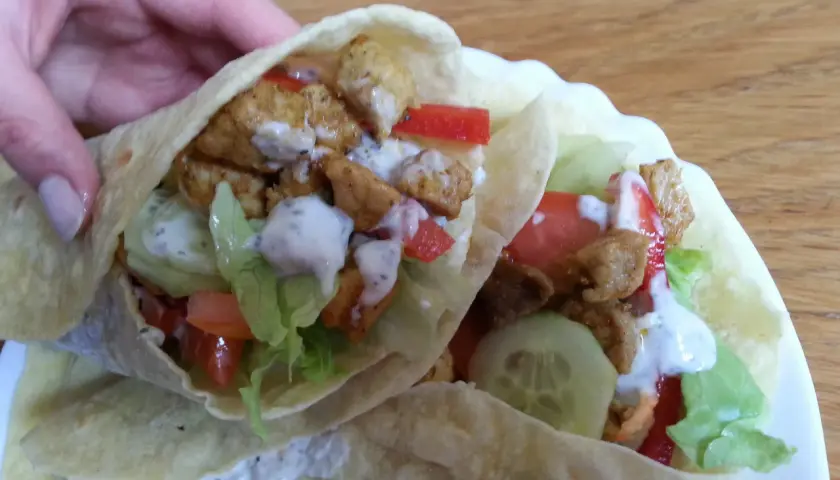 Dwie porcje pysznego, domowego kebaba w tortilli z kurczakiem, warzywami i sosem. Idealne na szybki lunch.