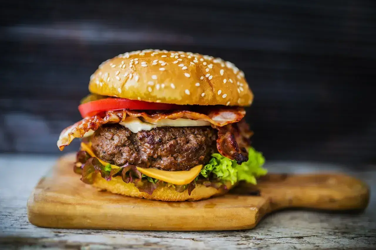 Soczysty burger z bekonem i serem, idealny przykład, jak przyprawić mięso na hamburgery.